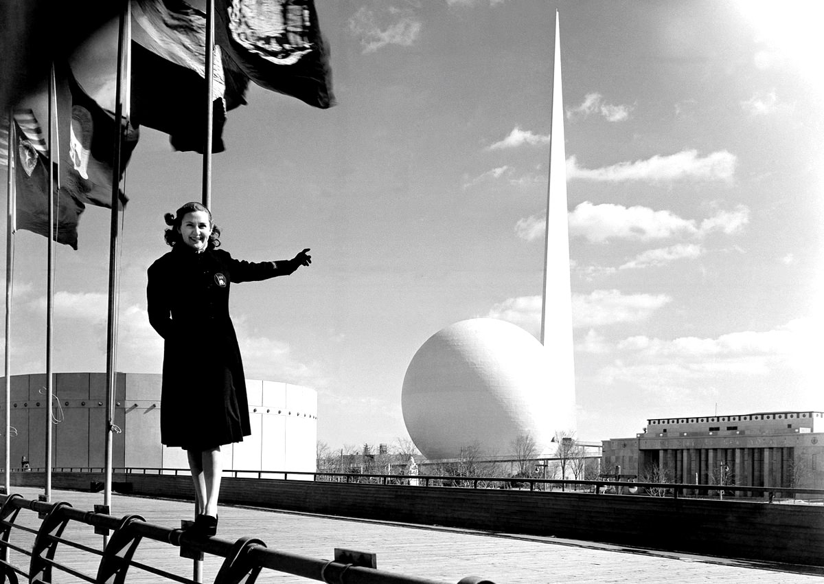 Rosalie Fairbanks, A Guide To The New York World'S Fair, Points To The Theme Of The Exposition -- The Trylon And Perisphere -- In New York On February 22, 1939,