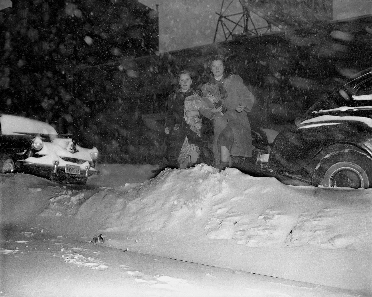 The Donovan Sisters, Elizabeth And Mary, Of 197 Flatbush Avenue., Brooklyn, Plunge Through Some Of That Borough'S Piled Drifts Of Dec. 26, 1947 Snow, Topped By Yesterday'S Fall.