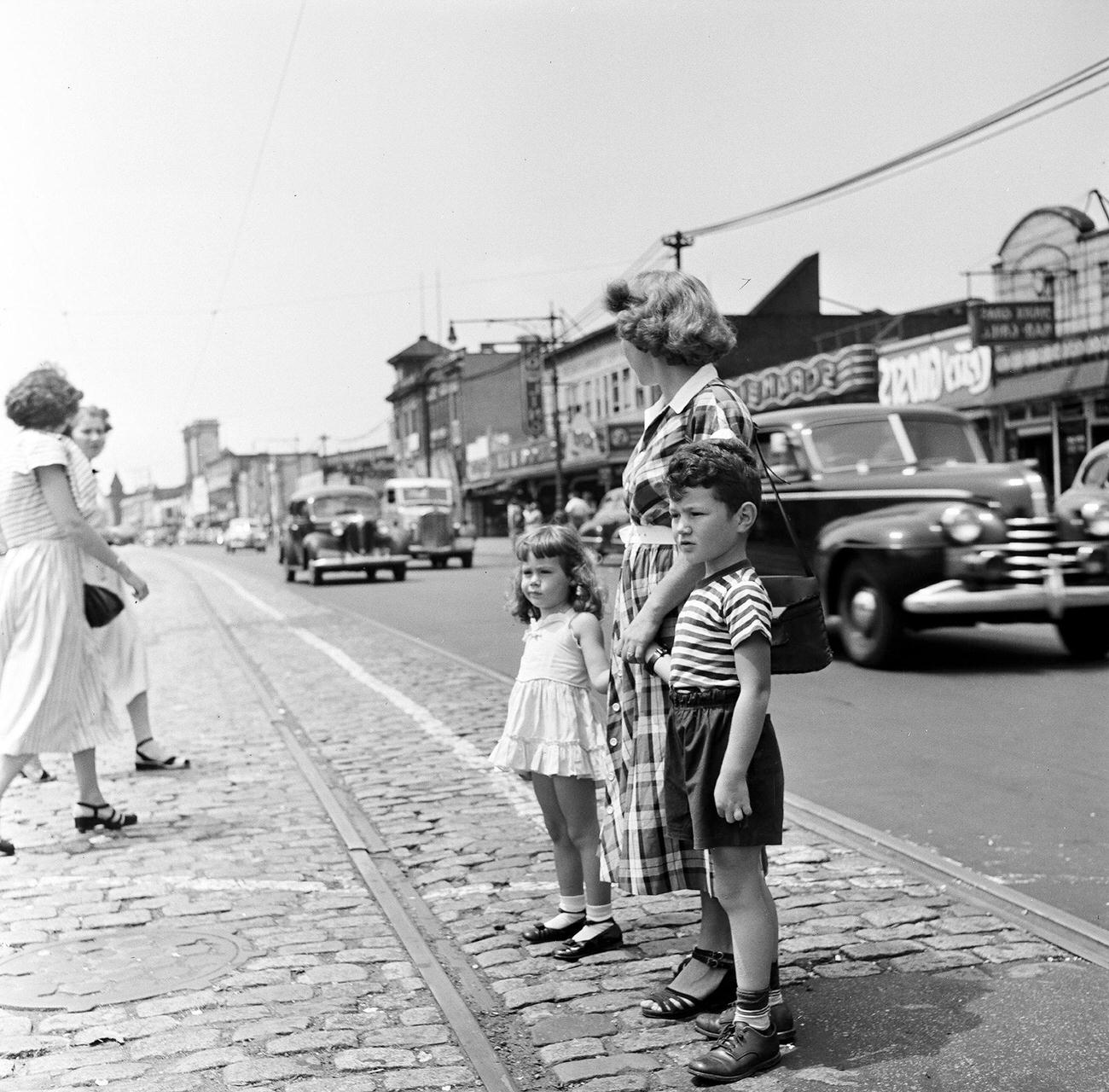 View Of Children Standing On Flatbush Avenue With Their Mother, 1948