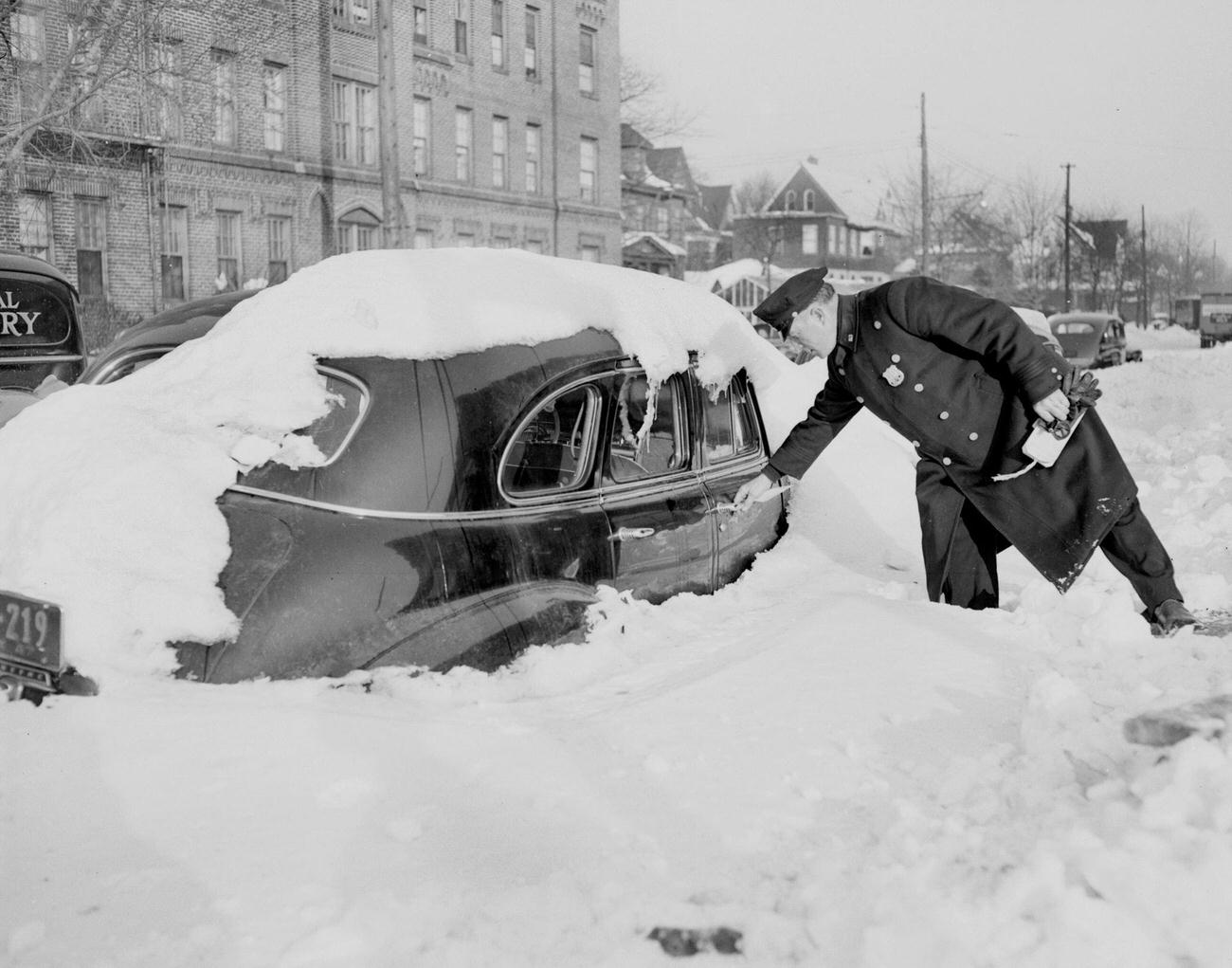 Patrolman James Mcgill Tags Auto Parked At Avenue H And Flatbush Ave., Brooklyn, 1940S. Motorists Were Warned To Keep Their Cars Off Streets And Thereby Facilitate Removal Of Snow.