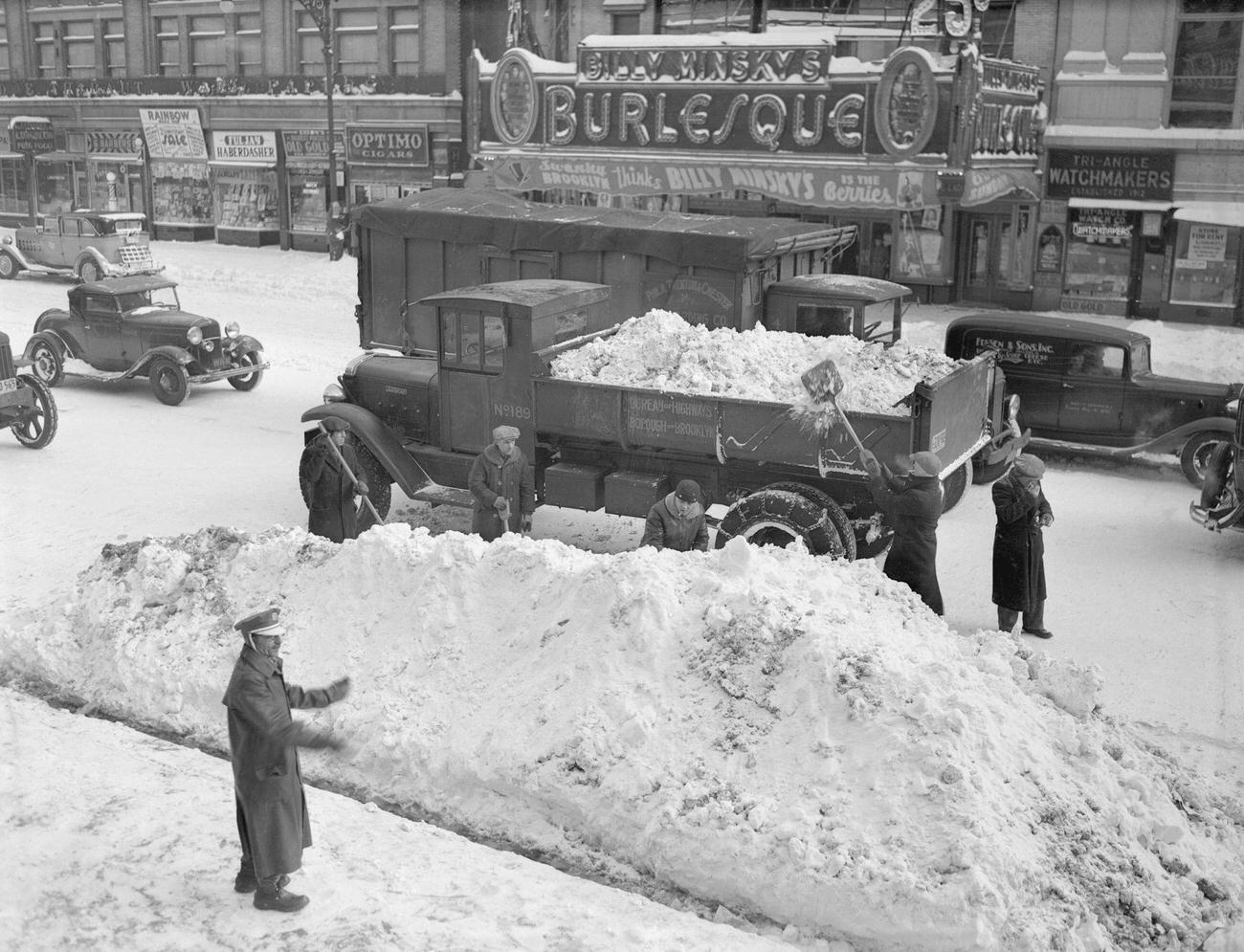 Department Of Sanitation Workers Clearing Flatbush Avenue In Brooklyn, The Morning Following New York'S Worst Snow Storm Since The Famed Blizzard Of 1888.