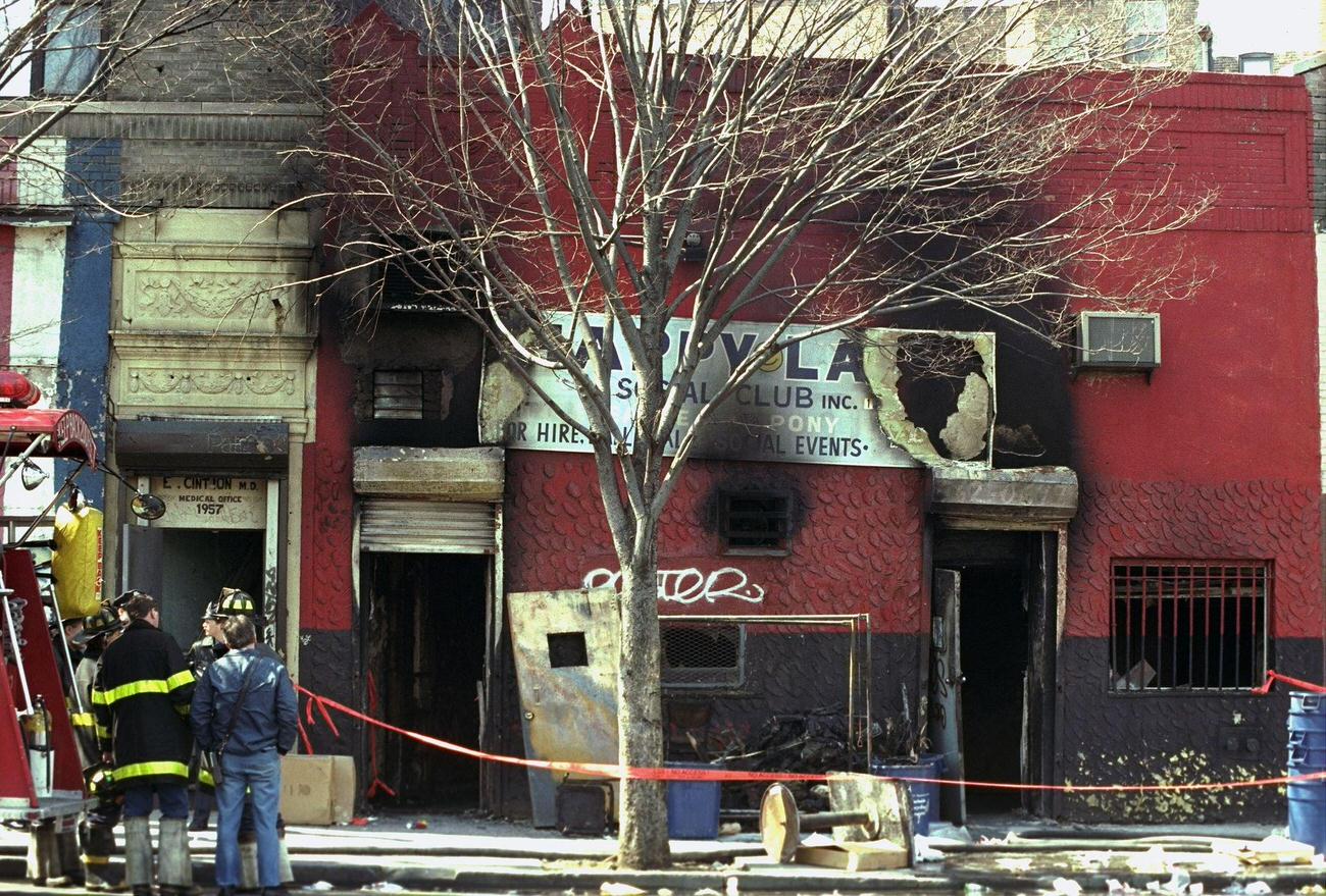 Firefighters Look At The Burned Remains Of The Happy Land Social Club