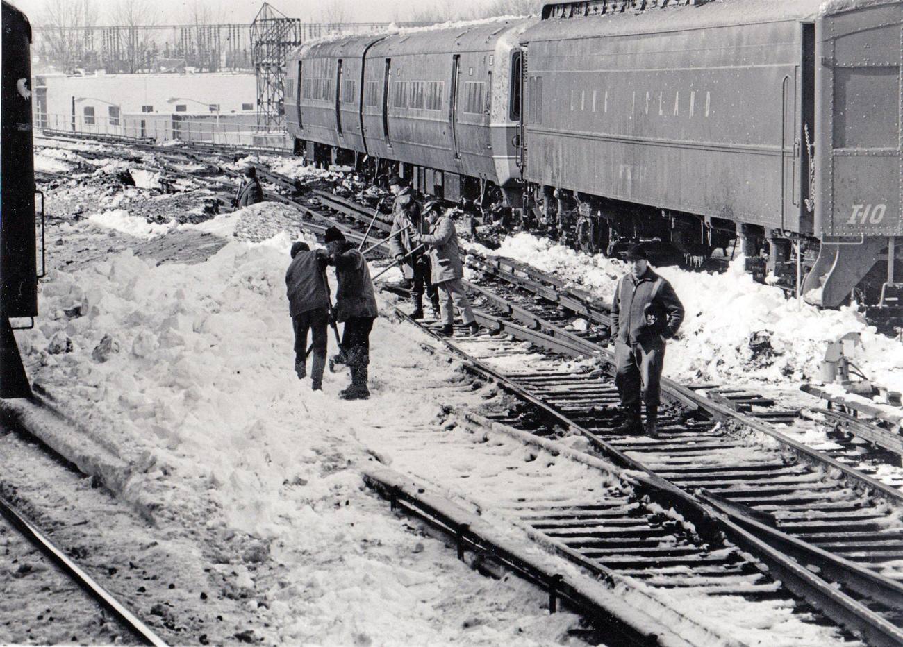 Track Crews Work With Shovels To Clear Snow From Switches And Third Rails Near The Jamaica, New York Station Of The Long Island Rail Road In On February 11, 1969.