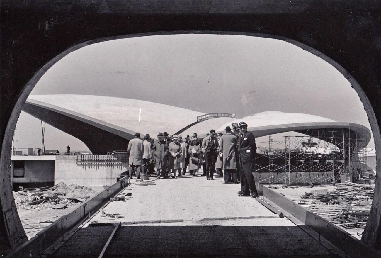 An Archway Frames Tourists Who Are Getting A Preview Of The New Trans World Airlines Building That Is Under Construction At Idlewild Airport (Later Jfk Airport) In Jamaica, New York On April 20, 1961.