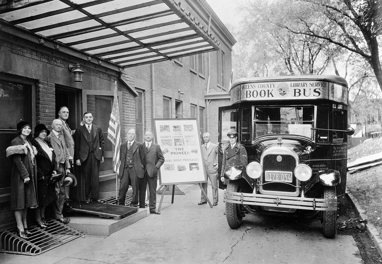 Franklin Delano Roosevelt standing with a group. Queens Borough Public Library