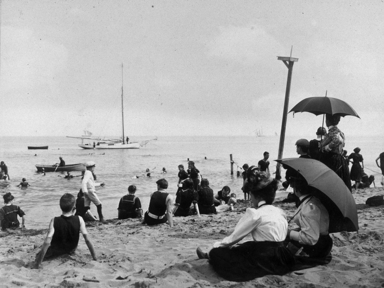 A Group Of Men, Women And Children Relaxing At Midland Beach, Staten Island, New York City, 1898