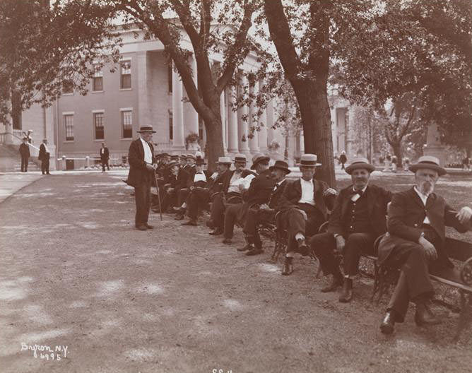 Men Seated On Benches, Smoking After Dinner, At Sailor'S Snug Harbor, A Facility And Home For Retired Sailors On Staten Island, 1890S
