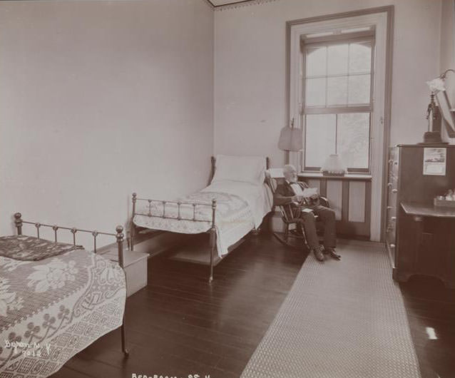 A Man In A Rocking Chair In A Bedroom At Sailor'S Snug Harbor, A Facility And Home For Retired Sailors On Staten Island, 1899