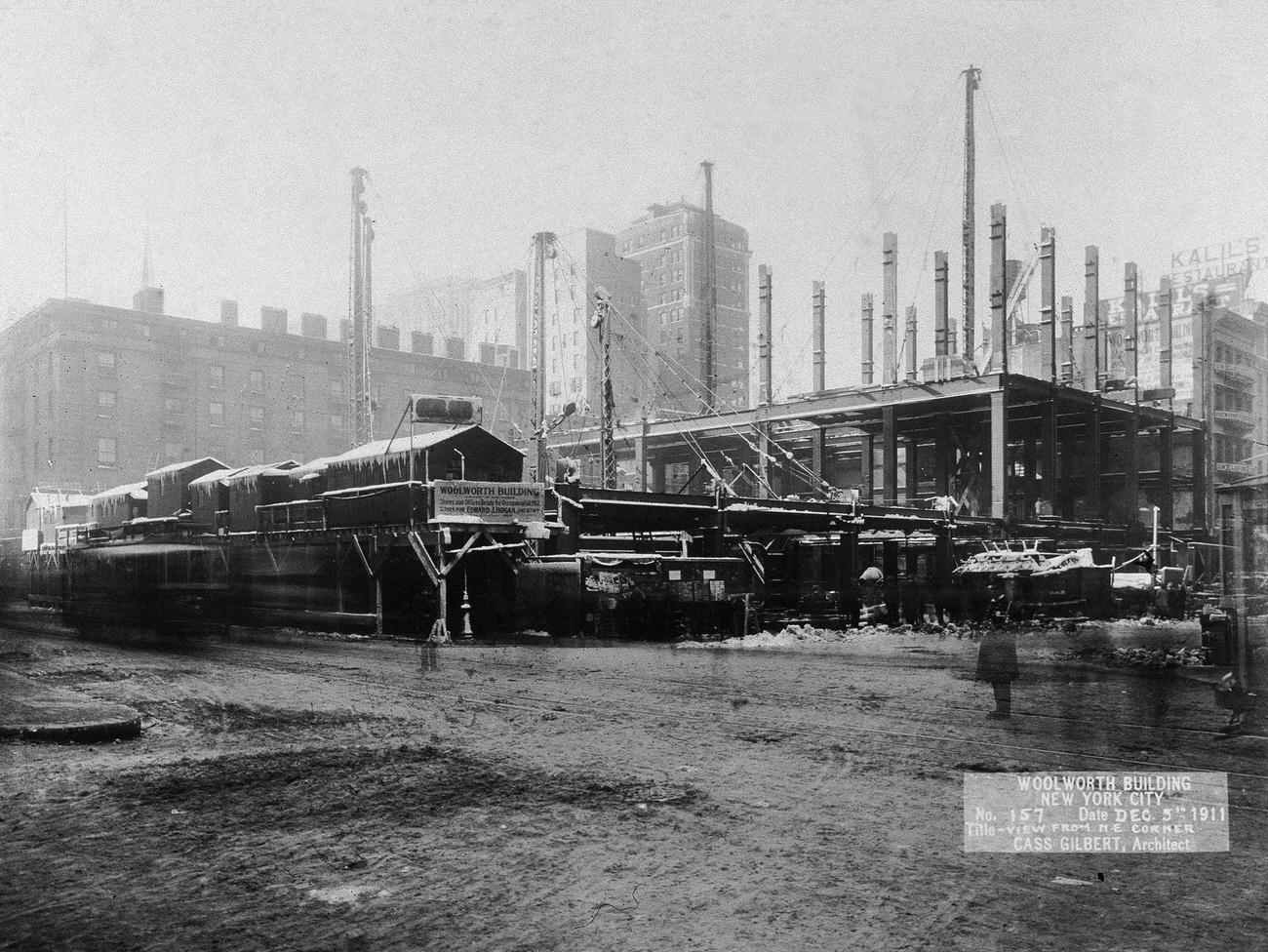 Police Officers Stand Guard Outside The Woolworth Building Construction Site, As Seen From The Northeast Corner, As A Trolley Car Speeds By, 1913.