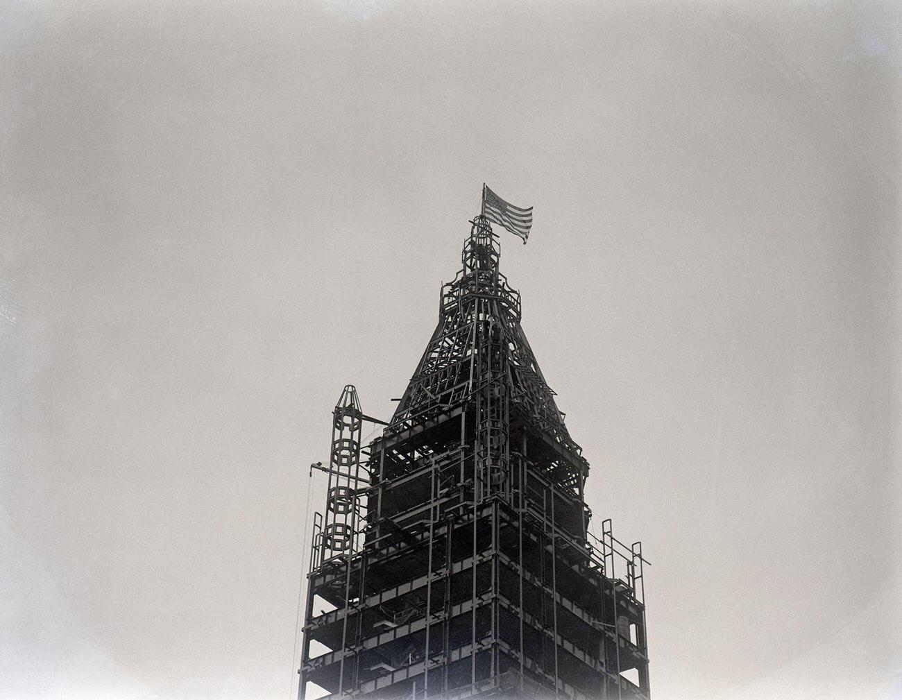 Woolworth Building Construction. Flag Showing Completion Of Iron Structure Framework, 1912