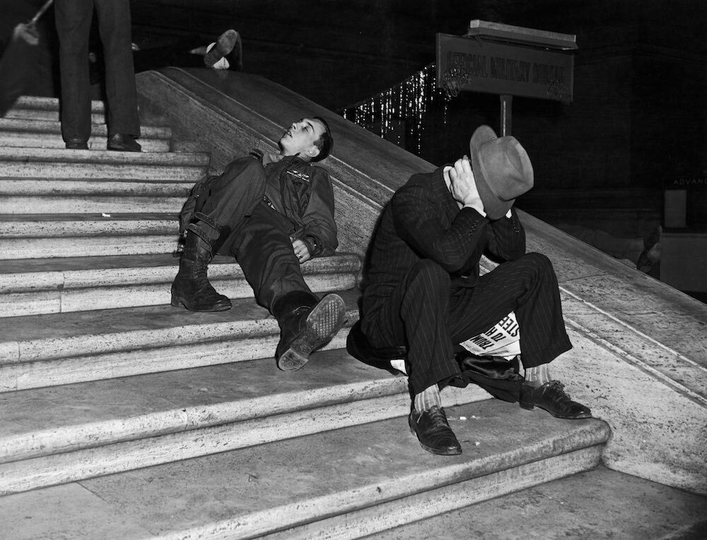 Revelers recover on the steps of Grand Central Station in New York after New Year’s Eve celebrations.