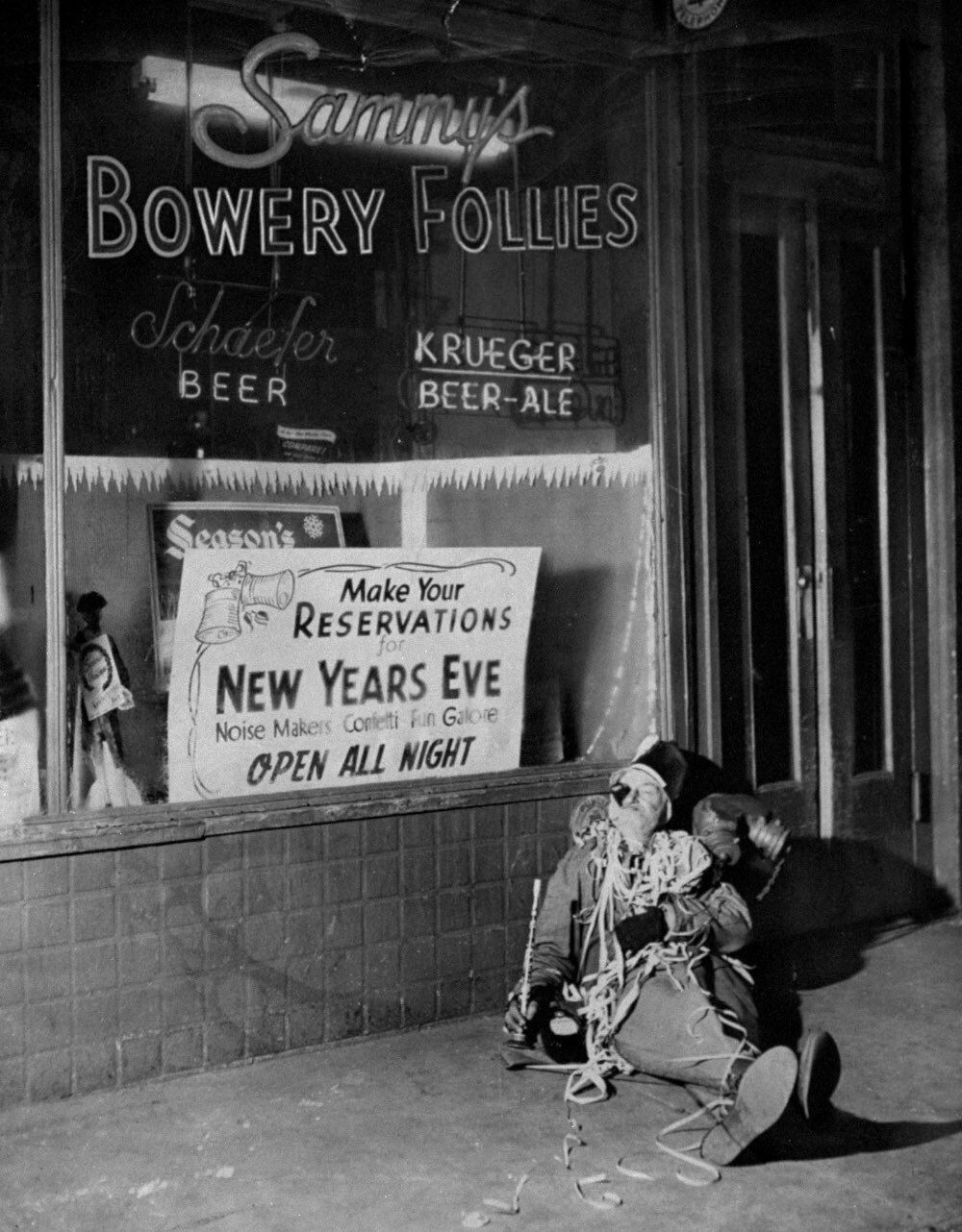 A gentleman sits outside the Bowery after he wasn’t able to get a seat to celebrate New Year’s Eve at Sammy’s Bowery Follies in New York.