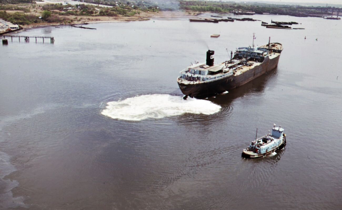 Mobile Oil Tanker And Tug Boat On Arthur Kill--The Waterway Between New Jersey And Staten Island Which Is The Site Of A Huge Petrochemical Manufacturing Complex, 1970S