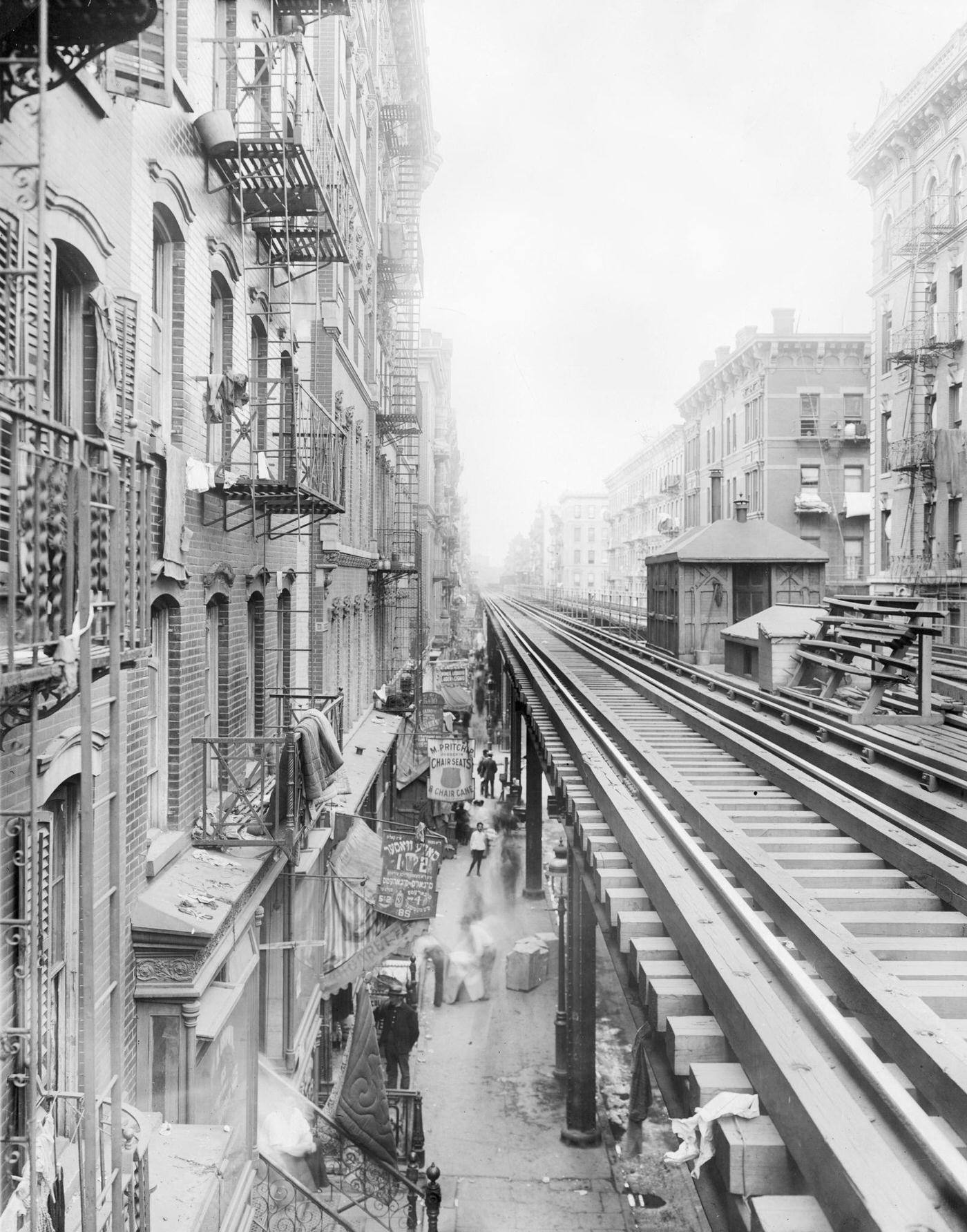 The Elevated 'El' Train Tracks Running Along Third Avenue Past Tenement Buildings, New York City, circa 1900