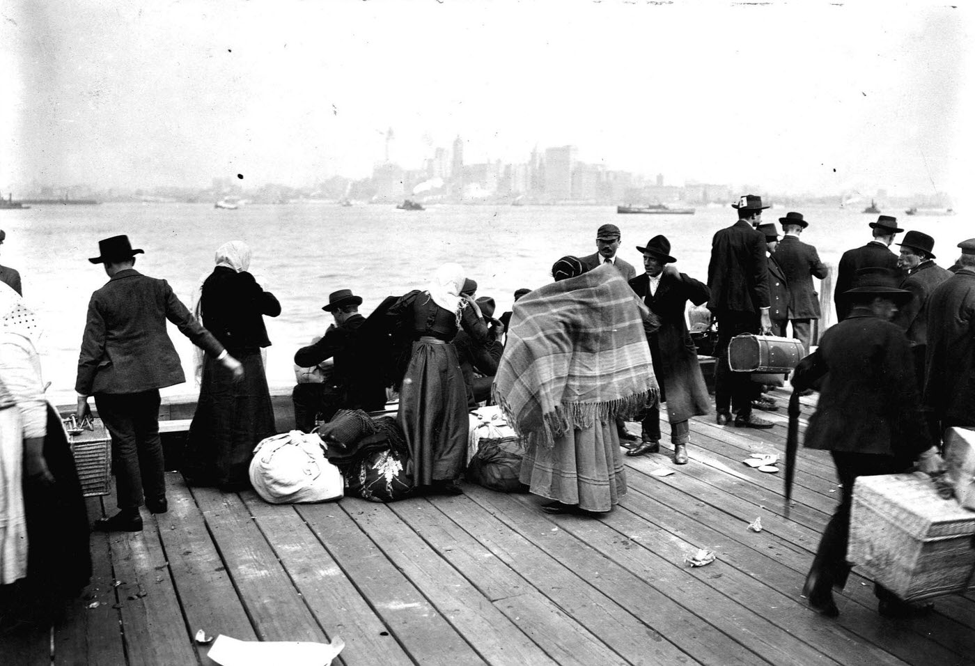 Immigrants Stand Outside At Ellis Island, Looking Towards Manhattan And New York Bay, 1912