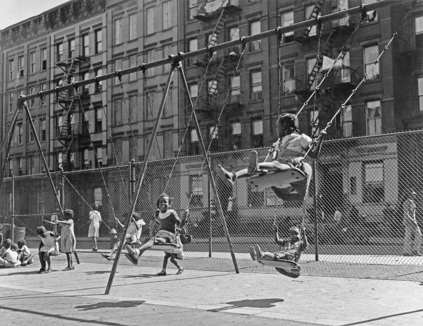 African-American Children Playing Swings At A Playground In Harlem, Manhattan, 1935.