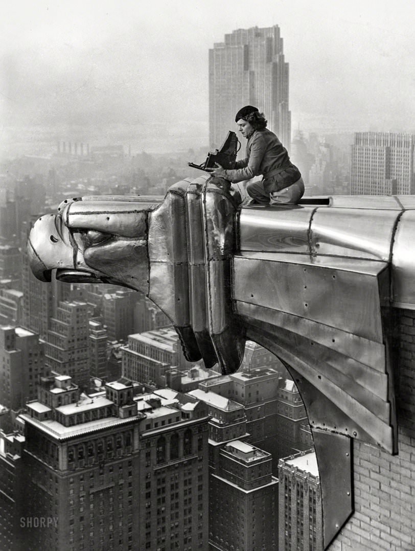 Margaret Bourke-White With Her Camera Atop A Stainless Steel Eagle Projecting From The Sixty-First Floor Of The Chrysler Building, Overlooking Manhattan And The Hudson River, New York City, 1934