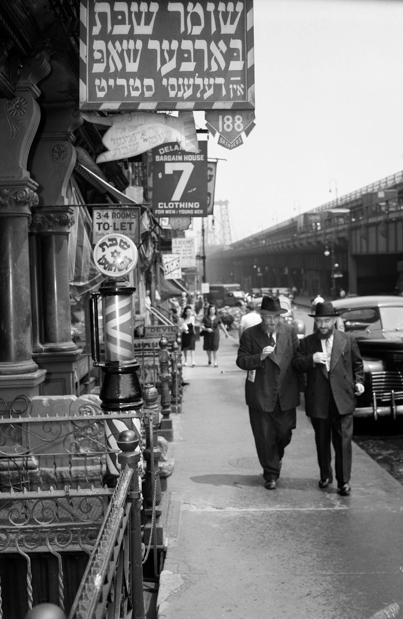 Lower East Side With Signs In Yiddish On Delancy Street, Barber Shop With Williamsburg Bridge In Background, Manhattan, 1940S