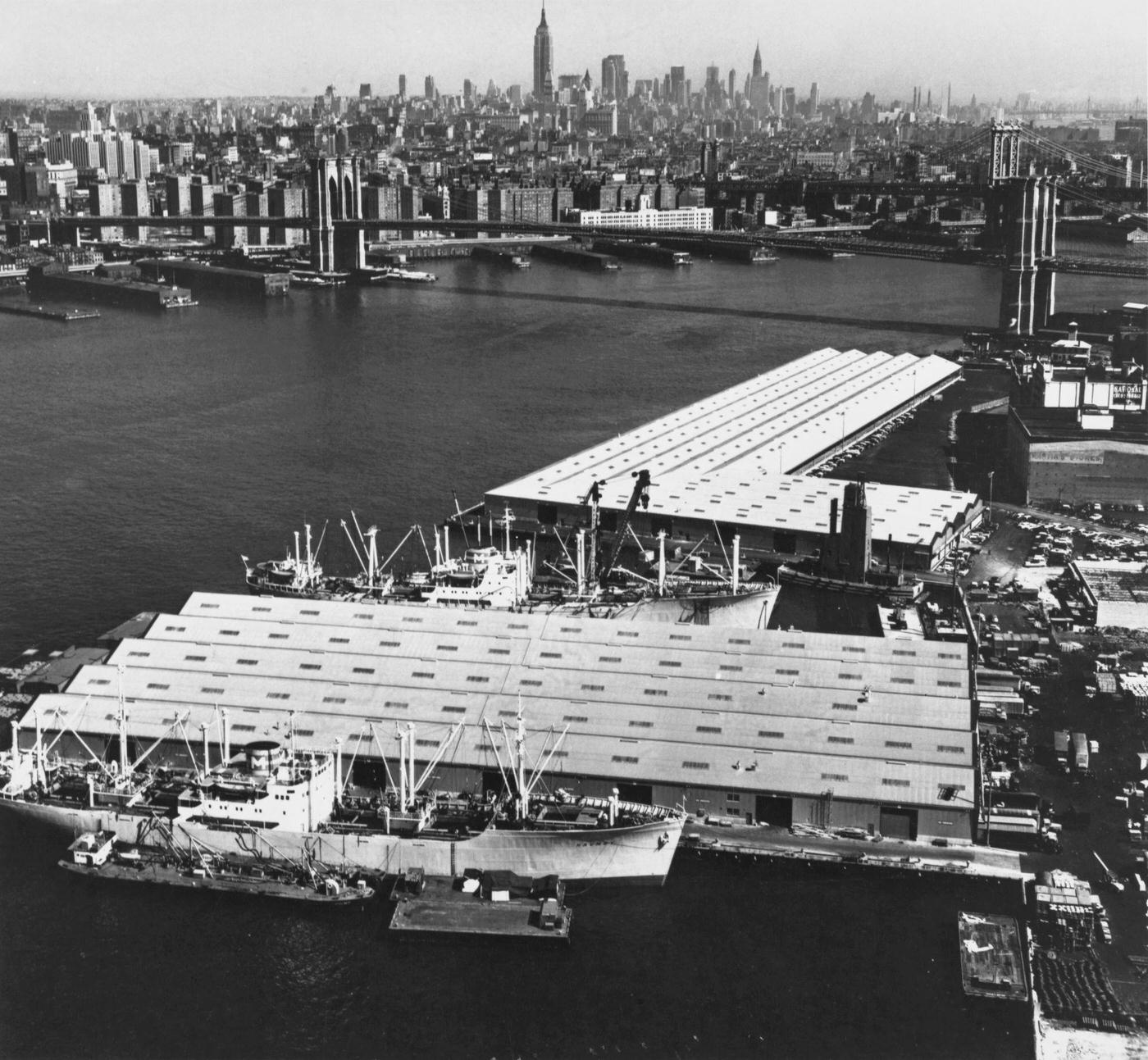 Brooklyn Waterfront Redevelopment Including High Angle View Of L-Shaped Three-Berth Pier 1 And Two-Berth Pier 2, Brooklyn Bridge And Manhattan Skyline, Manhattan, 1959