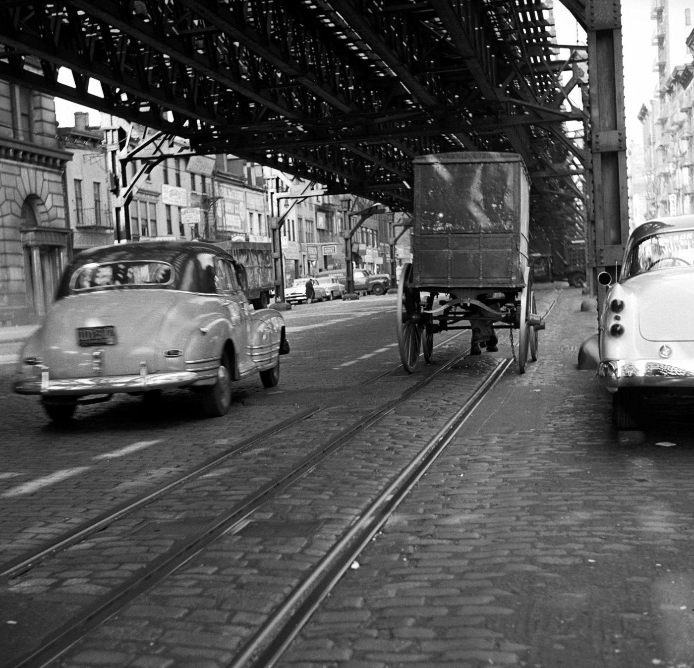 The Old And The New: Car Approaches Horse-Drawn Cart Under Train Tracks, Manhattan, 1954