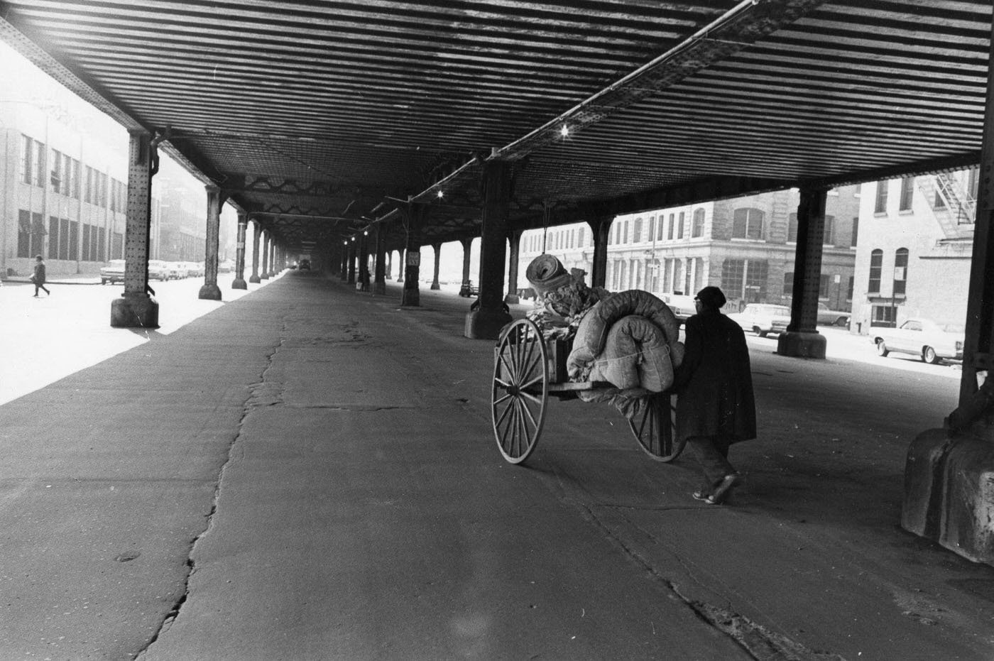 A Man Pushes A Cart Under The Elevated Train Tracks On Park Avenue In Manhattan, 1967