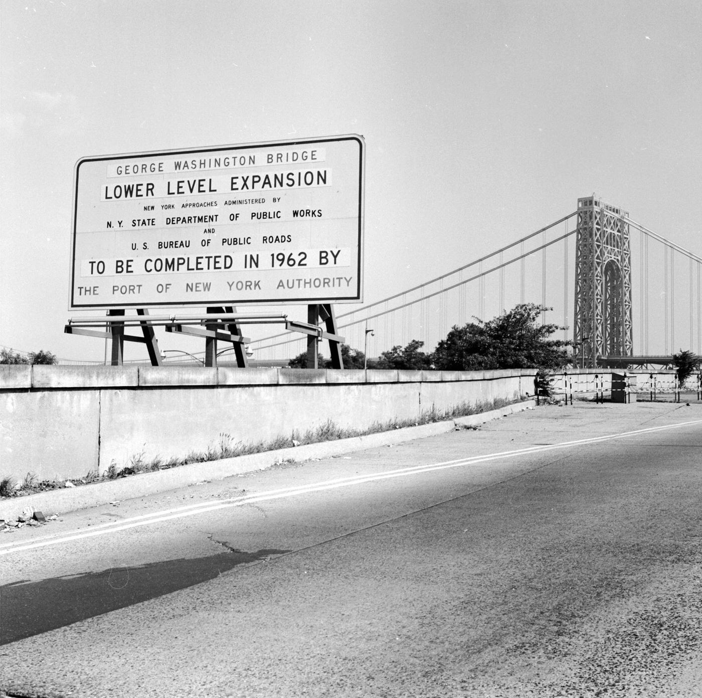 Sign Next To The George Washington Bridge Announcing The Completion Date Of The Bridge'S New Six-Lane Lower Deck, Manhattan, 1960