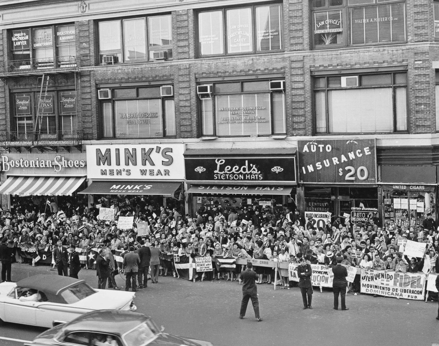 Critics And Supporters Of Fidel Castro Outside The Hotel Theresa, Displaying Banners, Stores Include Bostonian Shoes, Mink'S Men'S Wear, Leed'S Stetson Hats And Auto Insurance $20, Manhattan, 1960