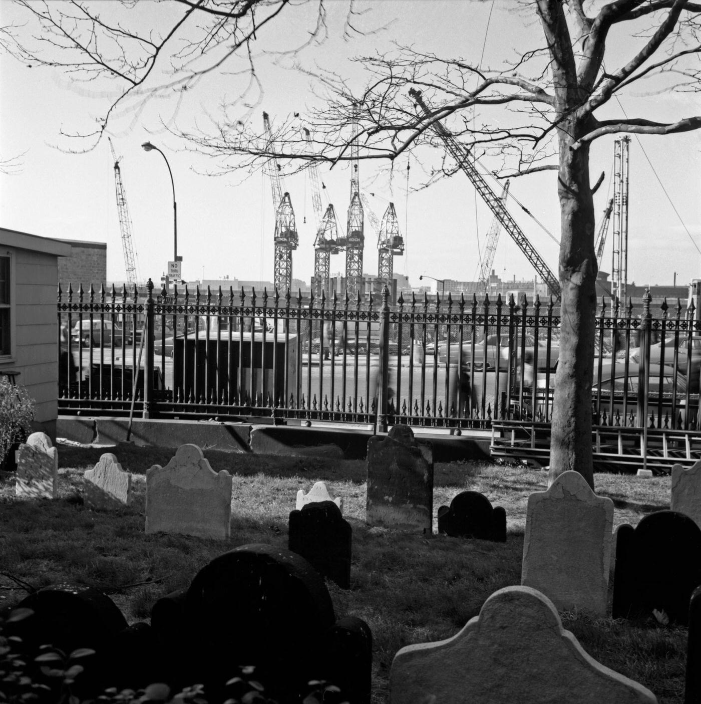 Construction Of Wtc Towers One &Amp;Amp; Two Near St. Paul'S Chapel, Gravestones Lining Church Street With Cranes In The Background, Manhattan, 1968