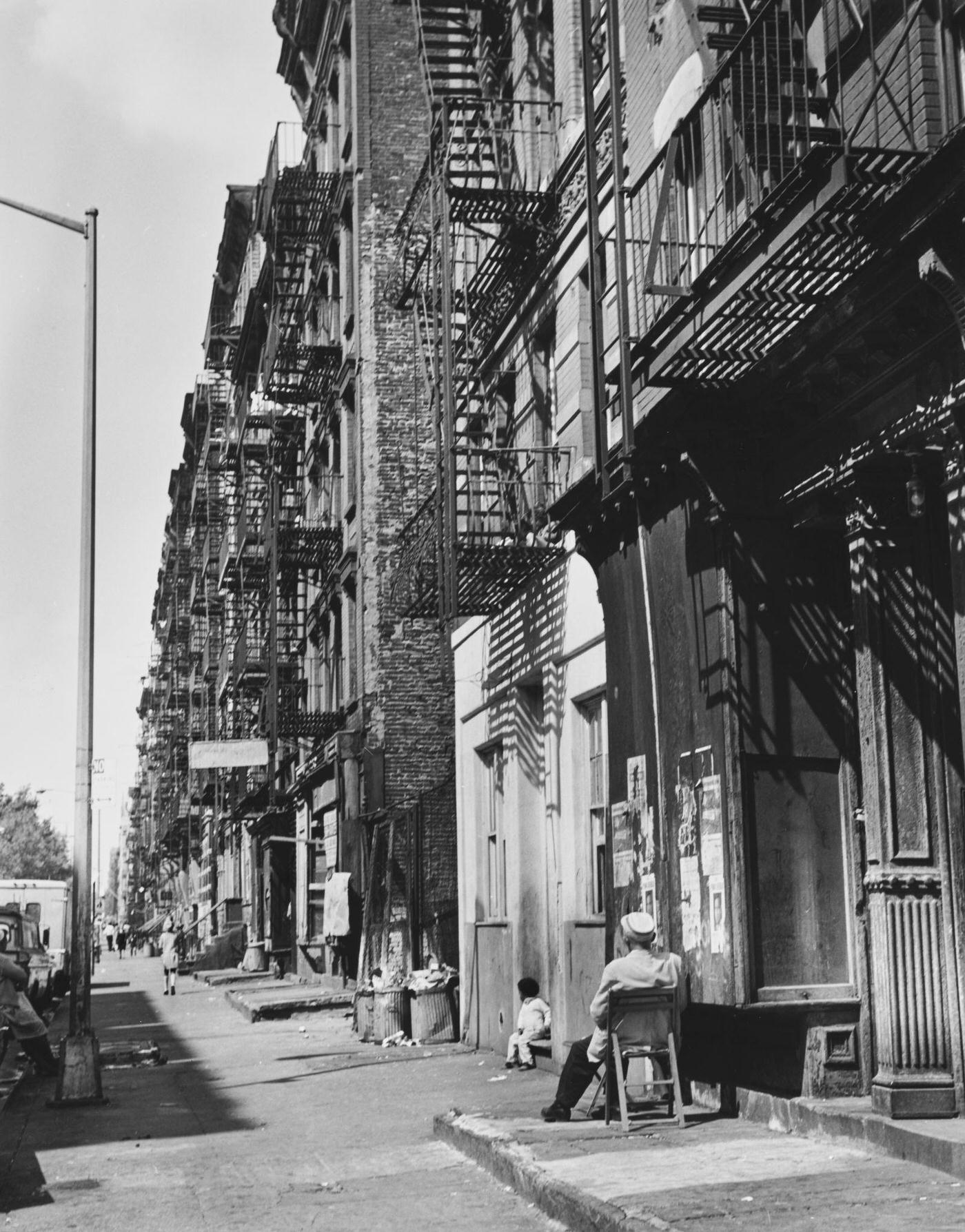 Man And Child In View Of Tenement Buildings On East 9Th Street, Manhattan, 1965