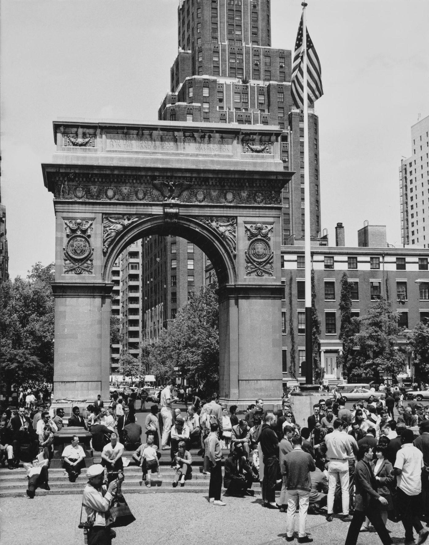 People Gather Around The South Face Of The Washington Arch In Washington Square Park, Lower Manhattan, 1965