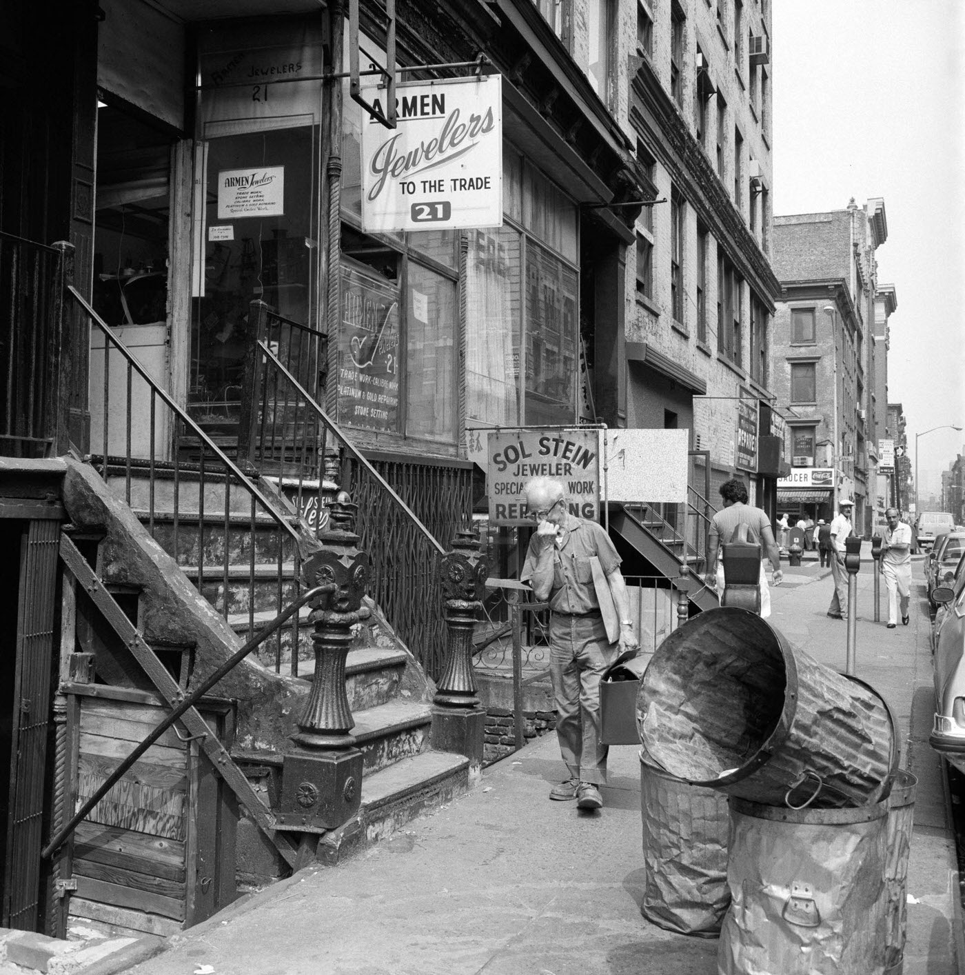 Pedestrians Walking Past Armen Jewelers And Sol Stein Jeweler On Eldridge Street, Manhattan, 1975.