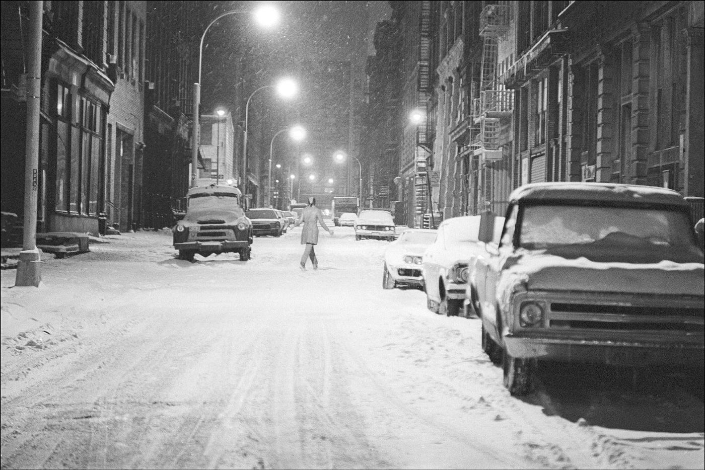 Nighttime View Of Pedestrian Crossing A Snow-Covered Street In Soho, Manhattan, 1974