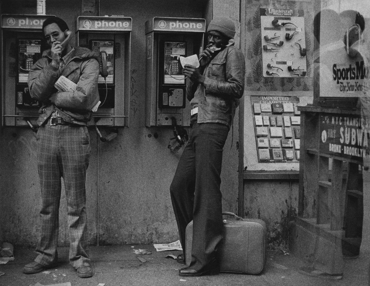 Two Young Men Making Phone Calls Near Times Square, Manhattan, 1975