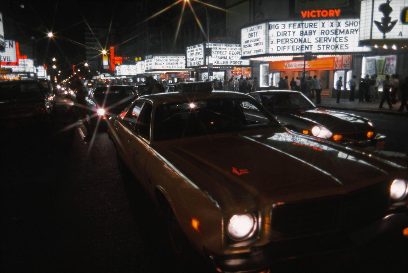 View of the Marquees of Cinemas on West 42nd Street Including the Victory Theatre, the Lyric Theatre, the Times Square Theater and the Apollo Theatre in Manhattan, 1976.