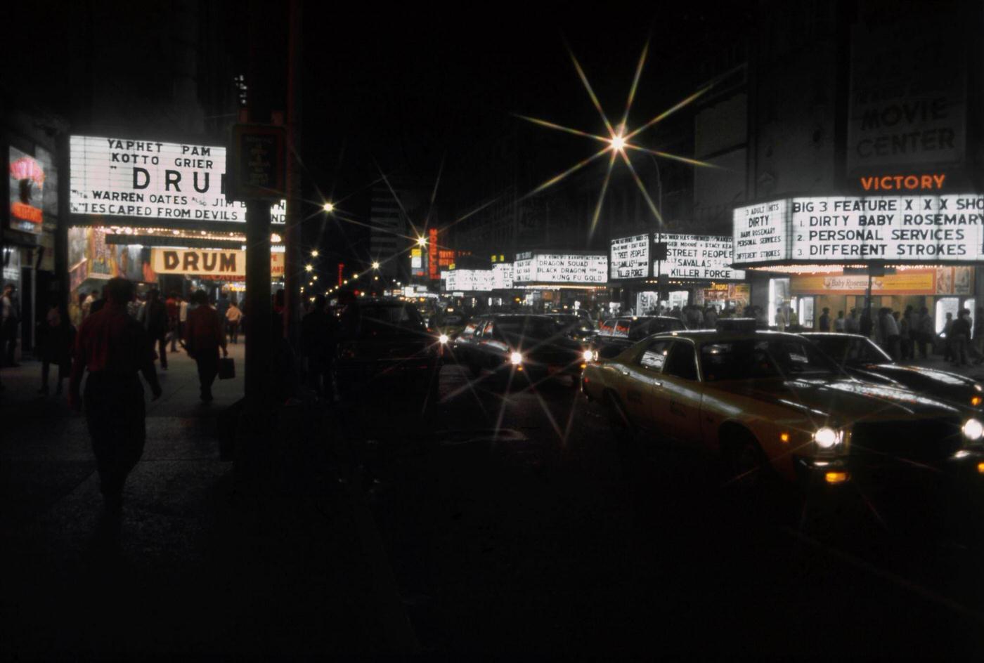 View of the Marquees of Cinemas on West 42nd Street Including the Victory Theatre, the Lyric Theatre, the Times Square Theater and the Apollo Theatre in Manhattan, 1976.