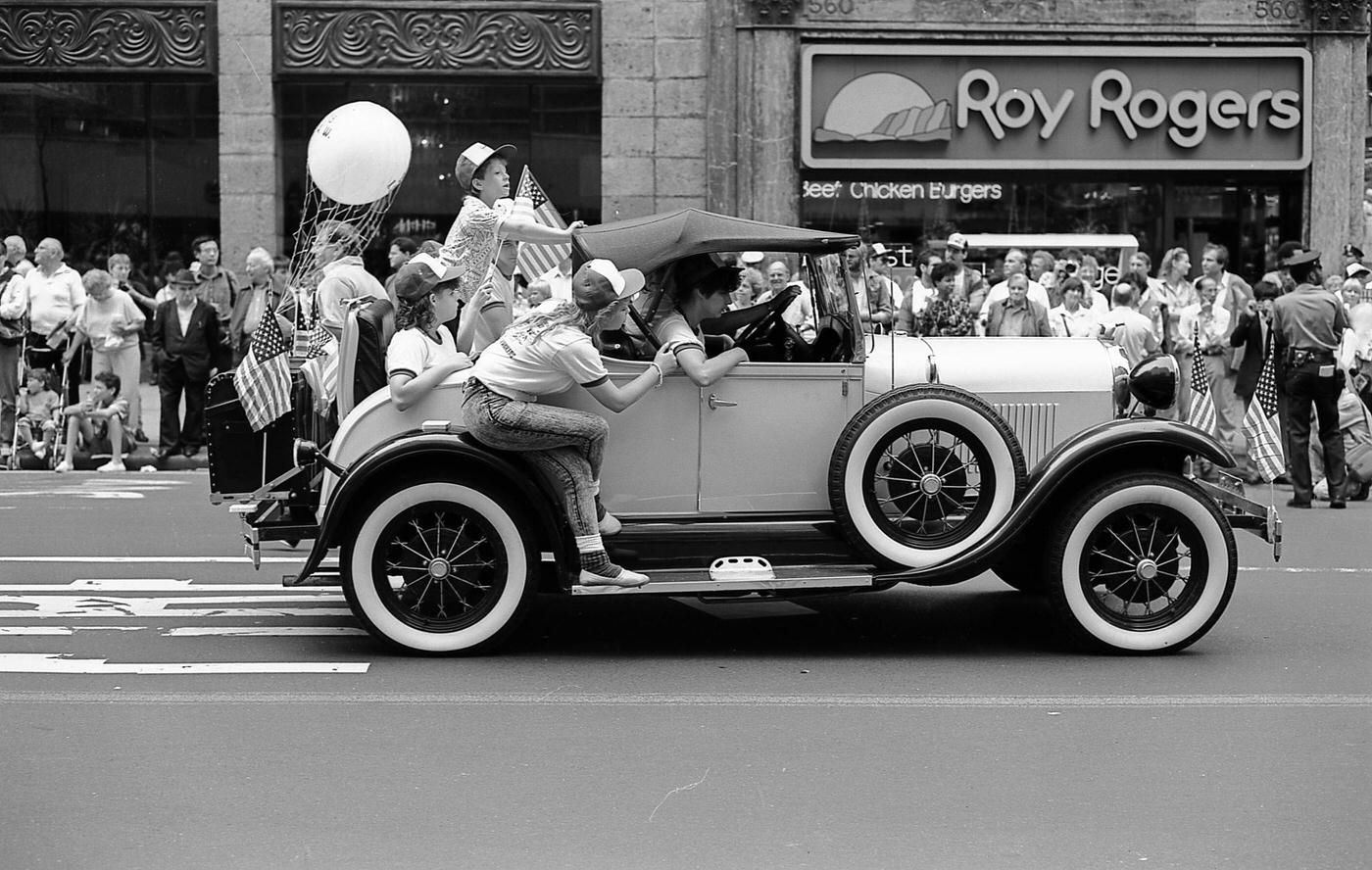 Vintage Car At The Labor Day Parade, Group Of People Riding In A Vintage Car On 5Th Avenue, Manhattan, 1987
