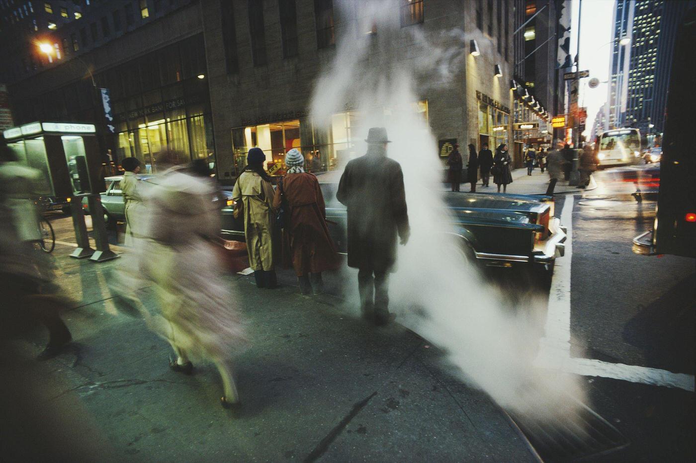Steam Hovers Over The Sidewalk During Rush Hour On Sixth Avenue, Manhattan, 1980.
