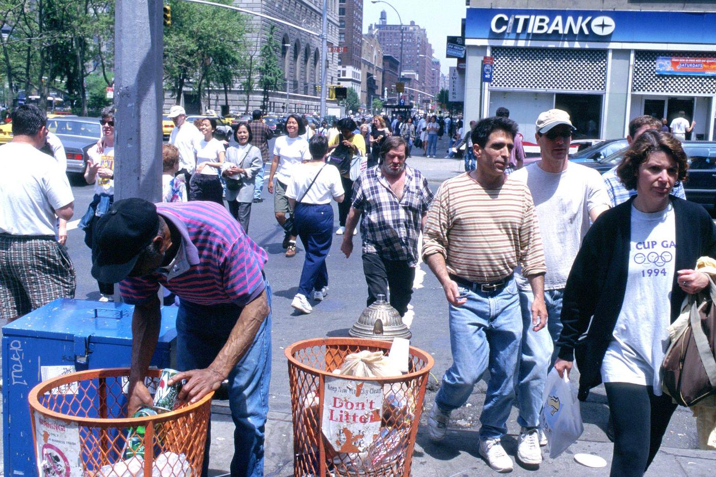 Many Pedestrians Passing Man Going Through Garbage On 72Nd St. &Amp;Amp; Broadway, Manhattan