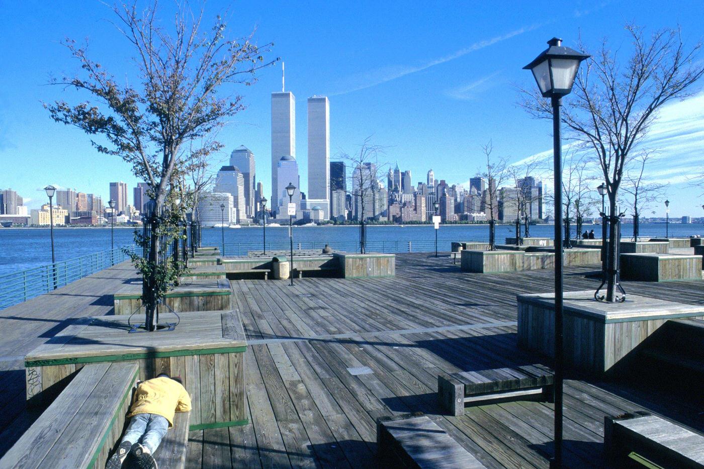 Person Lying On Bench Overlooking Lower Manhattan Including World Trade Center'S Twin Towers, Manhattan