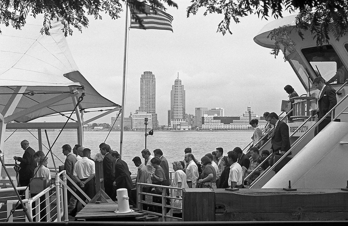 Commuters Exiting The Robert Fulton Ferry In Battery Park City, With The Hudson River And Jersey City Skyline Visible, Manhattan, 1997.