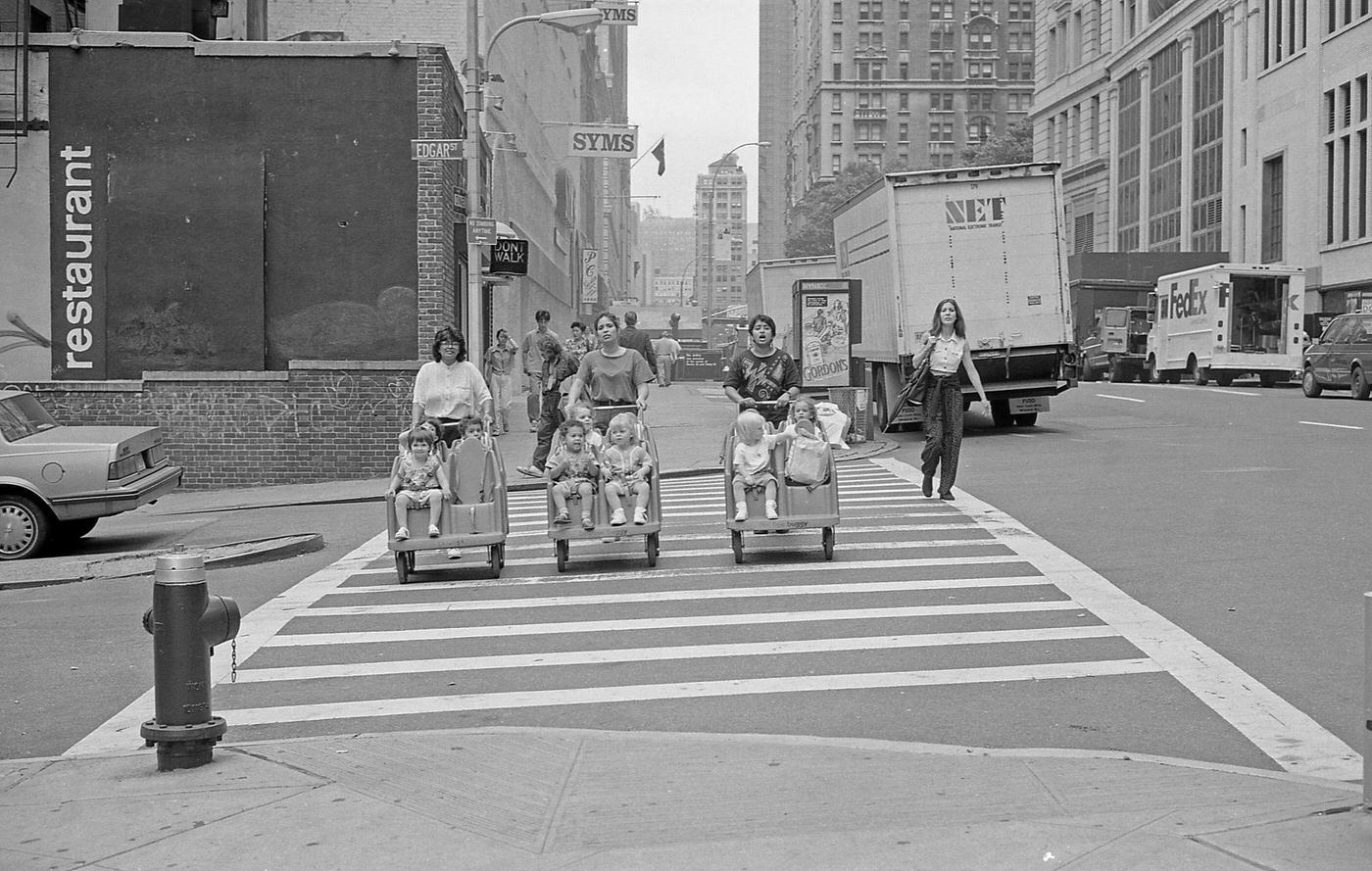 Three Women Pushing Dual Baby Carriages At Edgar Street And Trinity Place Intersection, Manhattan, 1997.