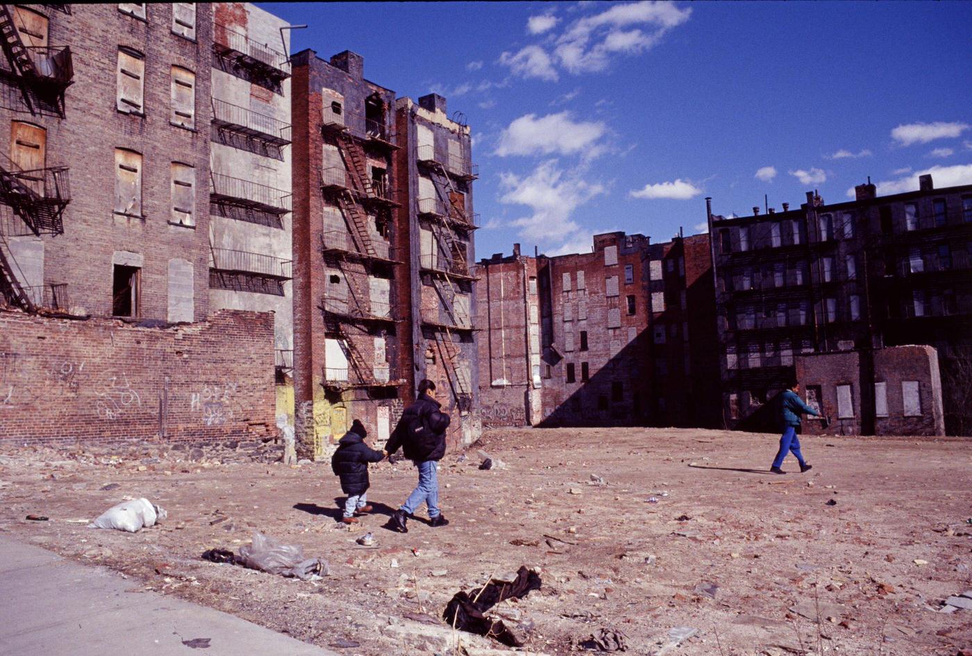 Several People Walking Across A Vacant Lot In Harlem, Manhattan, 1997.