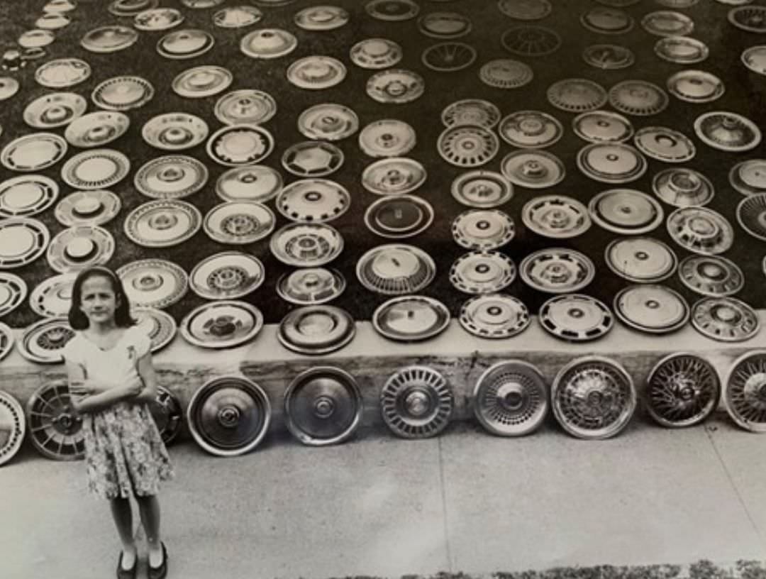 Huguenot Girl Selling Hubcaps In Front Of Her Home, 1984.