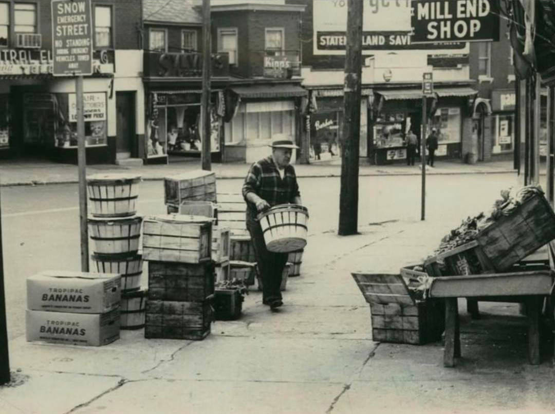 A Fruit Merchant Readies His Stand On Victory Boulevard, 1965.