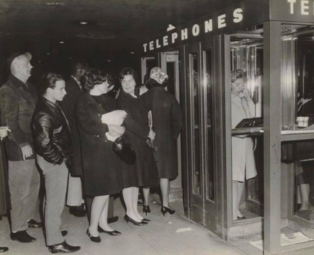Harried Commuters At The St. George Ferry Terminal Wait To Use Telephones, 1965.