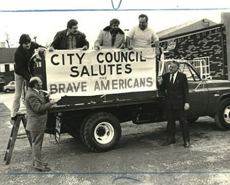 Councilmen Admire A Sign Celebrating The Return Of The Hostages From Iran, Jan 30, 1981.