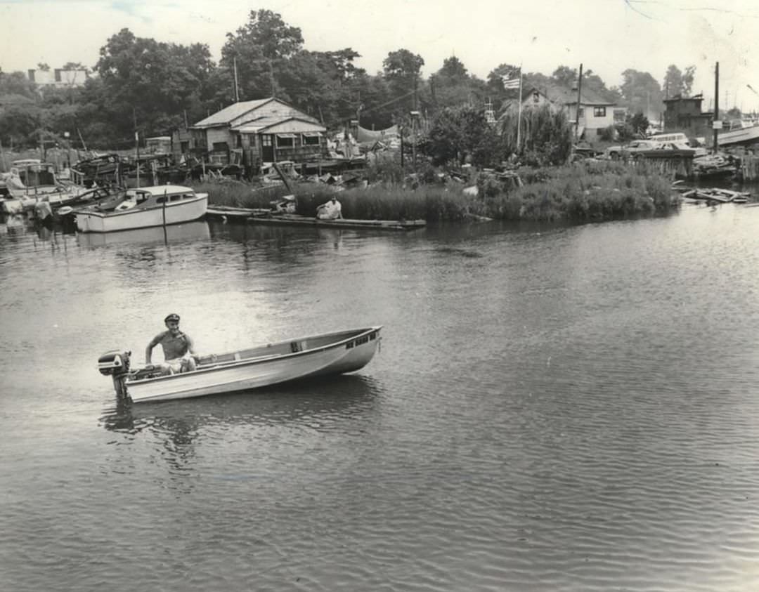 Boater Passing Houses On The Lemon Creek Waterfront, 1970