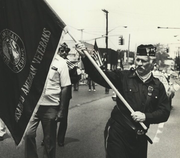 Memorial Day Parade Marcher Joseph Mcshane Shifts Flag Caught In The Wind, 1985.