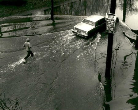 A Motorist Makes His Way Along A Flooded Road During Heavy Rain, Causing Traffic And Disruptions In The Area, 1985.