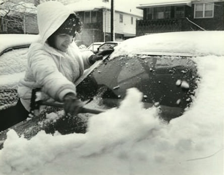 Beatrice Dickey Scraping Snow Off Her Car, Staten Island, April 6, 1982.